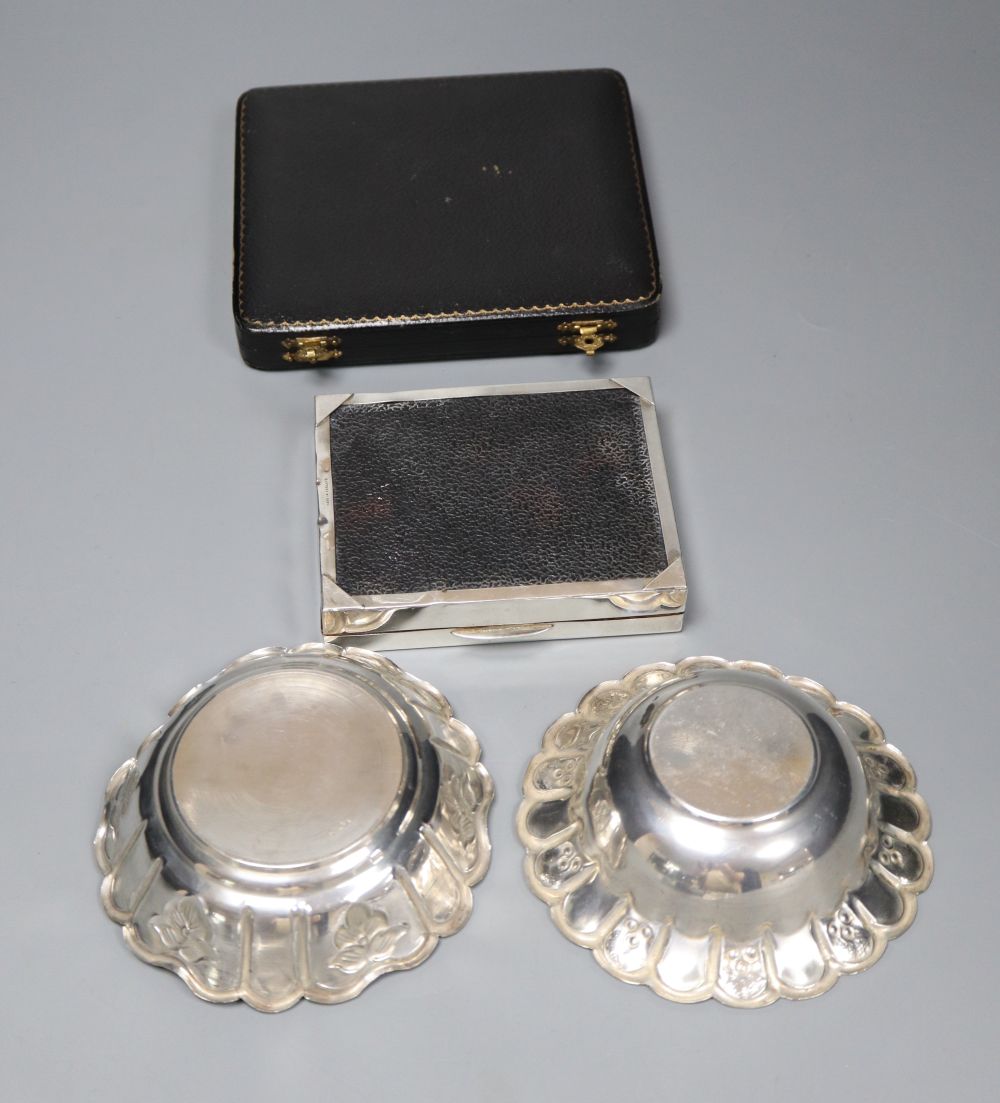 A cased set of six silver bean end coffee spoons, a silver cigarette box and two white metal dishes.